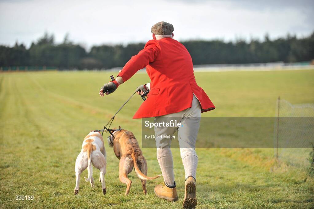 1 February 2010; Slipper Tom Murphy, slipping Same Over, red collar, and Chinese during the first round of the Hotel Minella Oaks. 85th National Coursing Meeting - Monday, Powerstown Park, Clonmel, Co. Tipperary. Picture credit: David Maher / SPORTSFILE