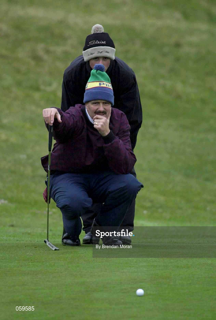 14 April 2001; Adrian Morrow of Portmarnock GC lines up a putt on the 7th green, assisted by his caddie James Gallagher during the West of Ireland Open Golf Championship at Sligo Golf Club in Rosses Point in Sligo. Photo by Brendan Moran/Sportsfile