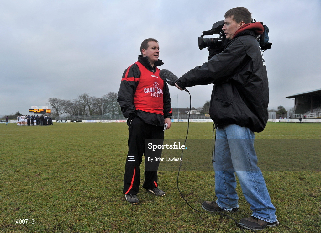 7 February 2010; Down manager James McCartan is interviewed for TV after the match, as the Kildare team conduct their post match team talk. Allianz GAA Football National League, Division 2, Round 1, Kildare v Down. St Conleth's Park, Newbridge, Co. Kildare. Picture credit: Brian Lawless / SPORTSFILE
