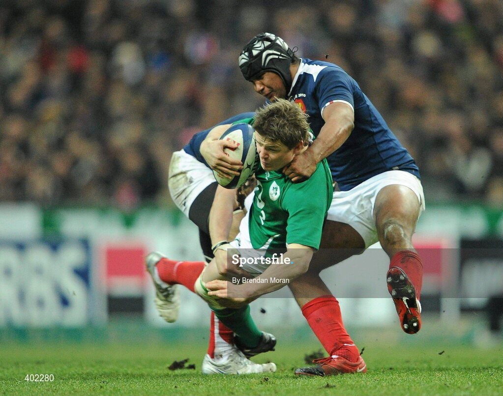 13 February 2010; Brian O'Driscoll, Ireland, is tackled by Imanol Harinordoquy, left, and theirry Dusautoir. RBS Six Nations Rugby Championship, France v Ireland, Stade de France, Saint Denis, Paris, France. Picture credit: Brendan Moran / SPORTSFILE