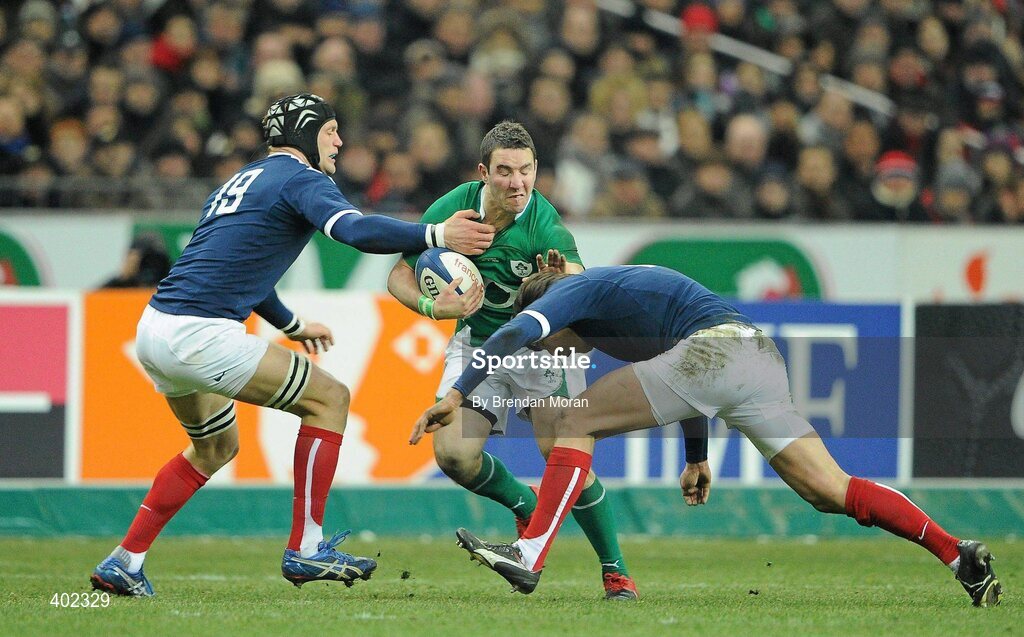 13 February 2010; Paddy Wallace, Ireland, is tackled by Julien Pierre, left, and Francois Trinh-Duc, France. RBS Six Nations Rugby Championship, France v Ireland, Stade de France, Saint Denis, Paris, France. Picture credit: Brendan Moran / SPORTSFILE