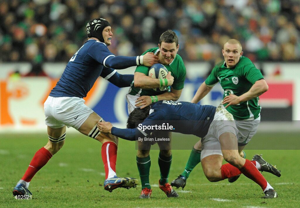13 February 2010; Paddy Wallace, supported by Keith Earls, right, Ireland, is tackled by Julien Bonnaire, left, and Francois Trinh-Duc, France. RBS Six Nations Rugby Championship, France v Ireland, Stade de France, Saint Denis, Paris, France. Picture credit: Brian Lawless / SPORTSFILE