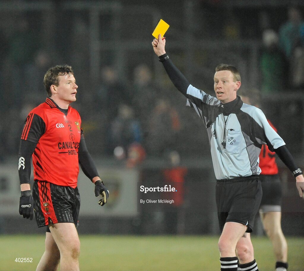 13 February 2010; Daniel McCartan, Down, receives a yellow card from referee Joe McQuillan. Allianz National Football League, Division 2, Round 2, Down v Meath, Pairc Esler, Newry, Co. Down. Picture credit: Oliver McVeigh / SPORTSFILE