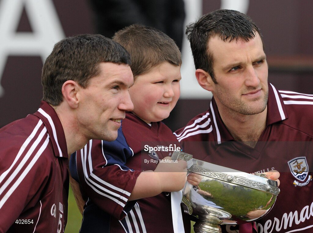 14 February 2010; Four-year-old Aaron Ryan, from Maynooth, Co Kildare, with the Walsh Cup and Galway players Niall Hayes, left, and captain Shane Kavanagh after the game. Walsh Cup Final, Dublin v Galway, Parnell Park, Dublin. Picture credit: Ray McManus / SPORTSFILE