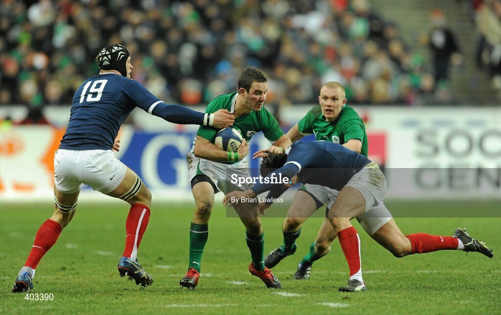 13 February 2010; Paddy Wallace, supported by Keith Earls, right, Ireland, is tackled by Julien Bonnaire, left, and Francois Trinh-Duc, France. RBS Six Nations Rugby Championship, France v Ireland, Stade de France, Saint Denis, Paris, France. Picture credit: Brian Lawless / SPORTSFILE *** Local Caption ***