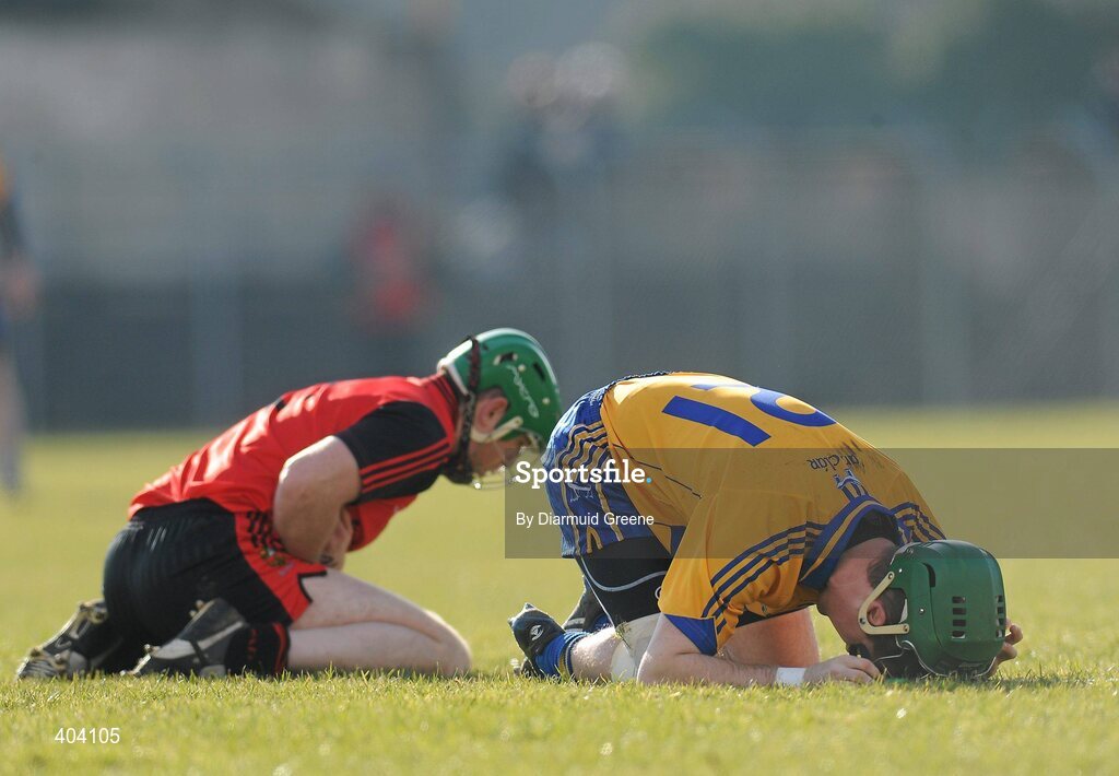21 February 2010; Clare's Colin Ryan and Down's Fintan Conway lay on the pitch after colliding during the game. Allianz GAA Hurling National League, Division 2 Round 1, Clare v Down. Cusack Park, Ennis, Co. Clare. Picture credit: Diarmuid Greene / SPORTSFILE