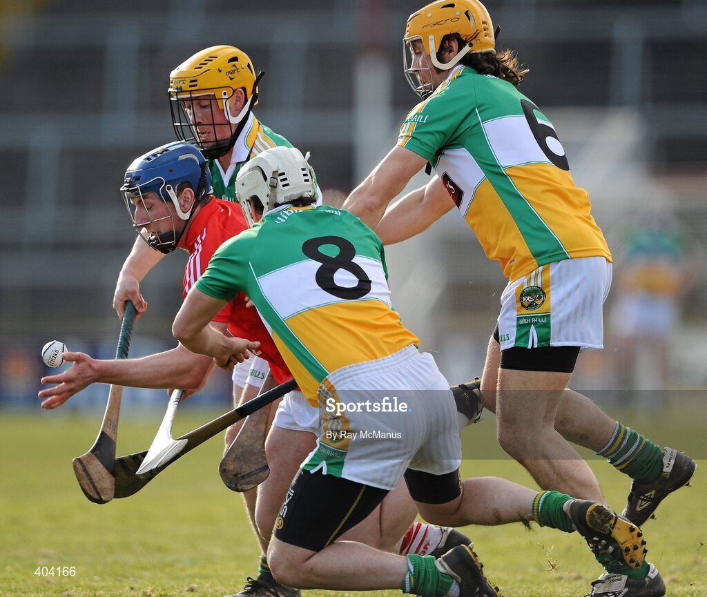 21 February 2010; Patrick Horgan, Cork, passes under pressure from Offaly players Dylan Hayden, 8, Ger Oakley, 6, and James Rigney. Allianz GAA Hurling National League Division 1 Round 1, Cork v Offaly. Pairc Ui Chaoimh, Cork. Picture credit: Ray McManus / SPORTSFILE