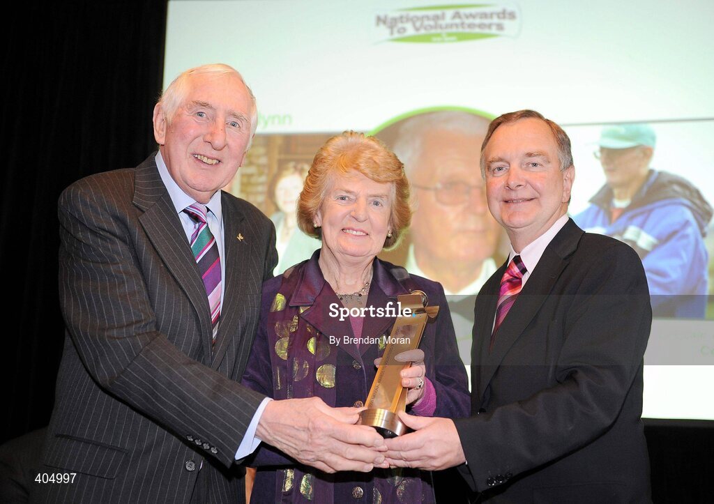 24 February 2010; Alda O'Gorman, on behalf of her brother Joe O'Flynn, receives the Community Administrator of the Year award from Irish Olympian Dr. Ronnie Delany, left, and Martin Cullen, TD, Minister for Arts, Sport and Tourism, at the Volunteers in Irish Sports Awards 2009. Farmleigh, Castleknock, Dublin. Picture credit: Brendan Moran / SPORTSFILE