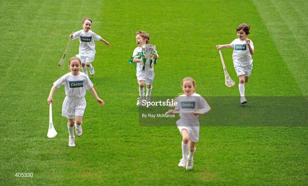 26 February 2010; GAA Stars of the future, Kelli and Alanna Clarke, Castleknock, Dublin, Anthony Lyons, Sandyford, Dublin, Dara O'Shaughnessy, Navan Road, Dublin, and Max Lally, Ashbourne, Co Meath, race across the pitch with the Liam MacCarthy Cup at the announcement of a new partnership with Centra and its 558 retail partners. Centra have been confirmed as an official sponsor of the GAA Hurling All-Ireland Championship. Croke Park, Dublin. Picture credit: Ray McManus / SPORTSFILE