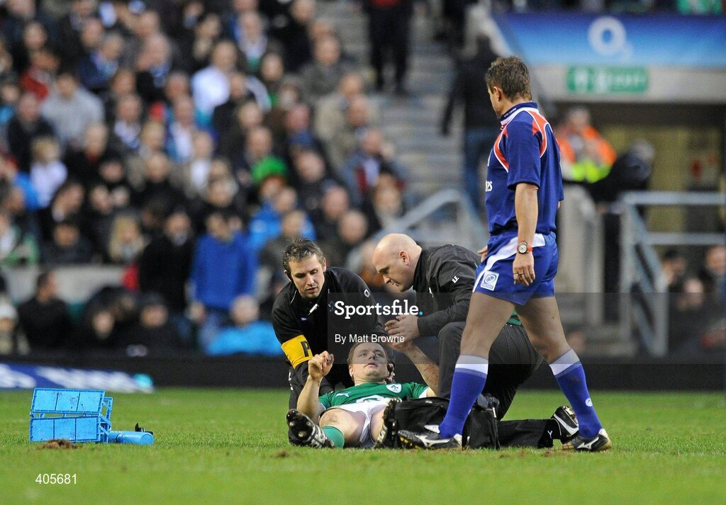 27 February 2010; Brian O'Driscoll, Ireland, receives attention from physio Cameron Steele, left, and team doctor Eanna Falvey as referee Mark Lawrence looks on. RBS Six Nations Rugby Championship, England v Ireland, Twickenham Stadium, Twickenham, London, England. Picture credit: Matt Browne / SPORTSFILE