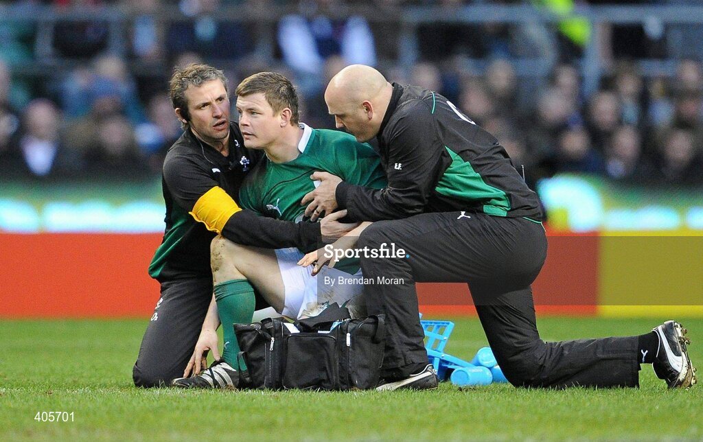 27 February 2010; Ireland captain Brian O'Driscoll is held by team physio Cameron Steele and team doctor Dr. Eanna Falvey after falling to the ground twice with suspected concussion during the game. RBS Six Nations Rugby Championship, England v Ireland, Twickenham Stadium, Twickenham, London, England. Picture credit: Brendan Moran / SPORTSFILE