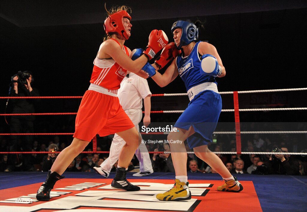 5 March 2010; Jessica Lyons, St Francis, Limerick, left, exchanges punches with Kelly Harrington, West Finglas, during their elite women's 69kg bout. National Men's & Women's Elite National Championships 2010 Finals - Friday, National Stadium, Dublin. Picture credit: Stephen McCarthy / SPORTSFILE