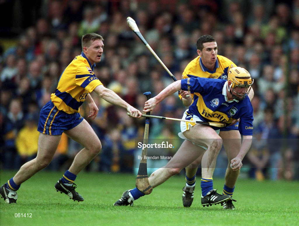 6 May 2001; Eamonn Corcoran of Tipperary in action against Jamesie O'Connor, left, and Tony Griffin of Clare during the Allianz National Hurling League Final match between Tipperary and Clare at the Gaelic Grounds in Limerick. Photo by Brendan Moran/Sportsfile *** Local Caption ***