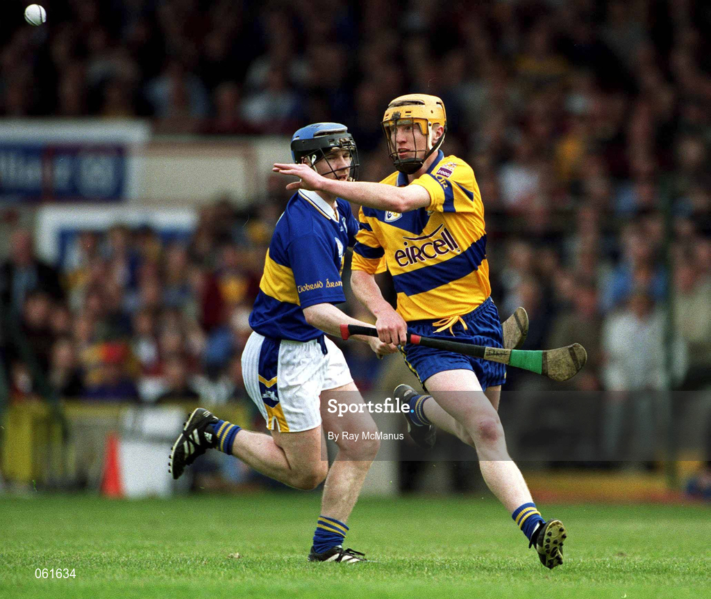 6 May 2001; Niall Gilligan of Clare gets a handpass away despite the tackle of Thomas Costello of Tipperary during the Allianz National Hurling League Final match between Tipperary and Clare at the Gaelic Grounds in Limerick. Photo by Ray McManus/Sportsfile *** Local Caption ***