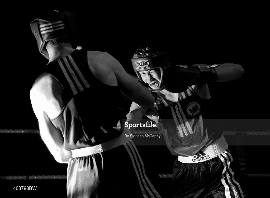 19 February 2010; David Stephenson, red, exchanges punches with Stephen Reville, blue, during their 75kg Novice bout. National Mens and Womens Elite National Boxing Championships, Preliminary Rounds, National Stadium, Dublin. Picture credit: Stephen McCarthy / SPORTSFILE