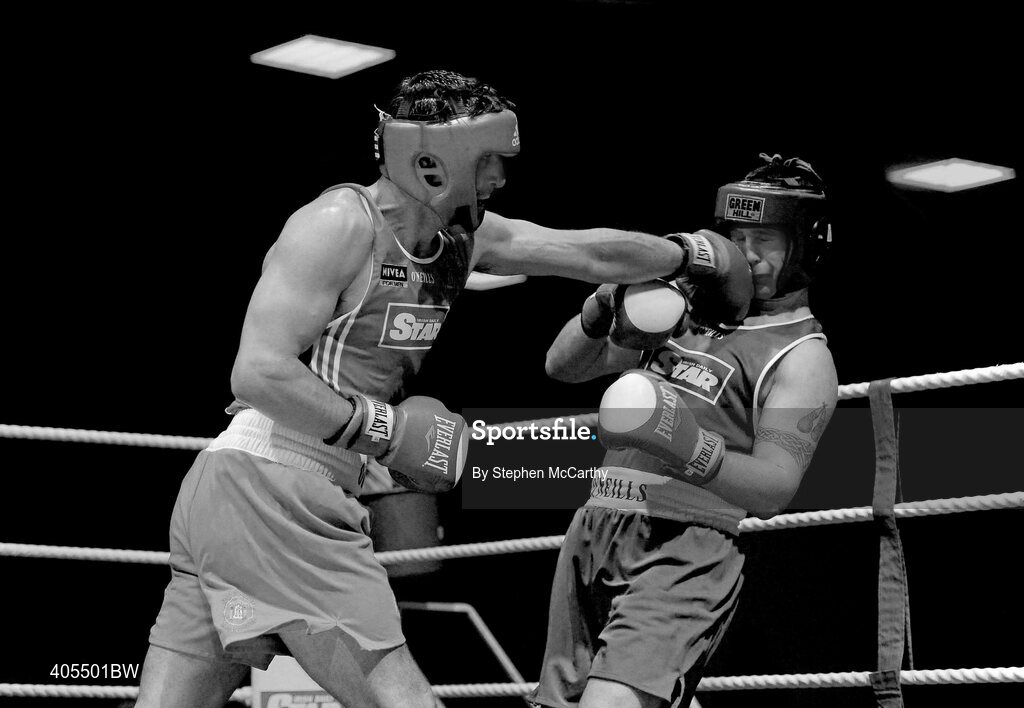 20 February 2010; Kenny Egan, Neilstown, red lands a left on Denis Hogan, Grangecon, blue, during their 81kg bout. National Boxing Championships - Semi-Finals, National Stadium, Dublin. Picture credit: Stephen McCarthy / SPORTSFILE
