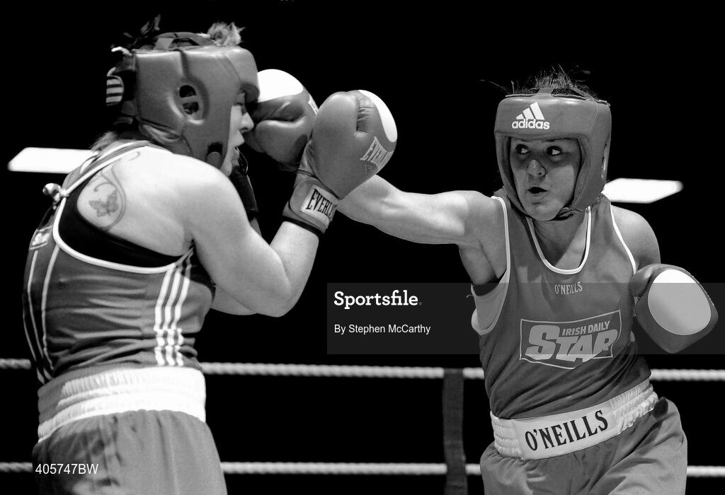 27 February 2010; Kelly Harrington, West Finglas, red, exchanges punches with Patricia Roddy, Bray, blue, during their elite women's 69kg bout. National Mens & Womens Elite Championships Semi-Finals - Saturday, National Stadium, Dublin. Picture credit: Stephen McCarthy / SPORTSFILE