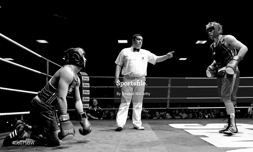 20 February 2010; Ray Moylett, St Annes, blue, picks himself up from the canvas as Philip Sutcliffe, Crumlin, is told to stand back by the referee during their 64kg bout. National Boxing Championships - Semi-Finals, National Stadium, Dublin. Picture credit: Stephen McCarthy / SPORTSFILE