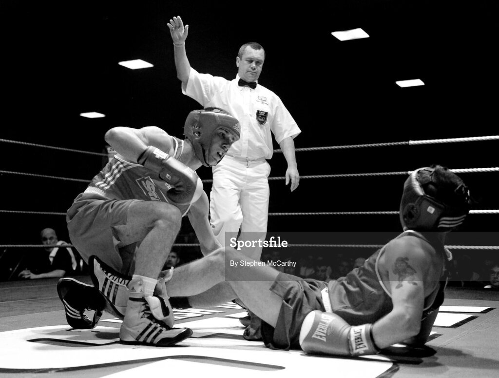 6 March 2010; John Joe Nevin, Cavan, left, and Derek Thorpe, St Aidans, fall to the canvas during their men's elite 54kg final bout. Men's Elite & Women's Novice National Championships 2010 Finals - Saturday Evening Session, National Stadium, Dublin. Picture credit: Stephen McCarthy / SPORTSFILE