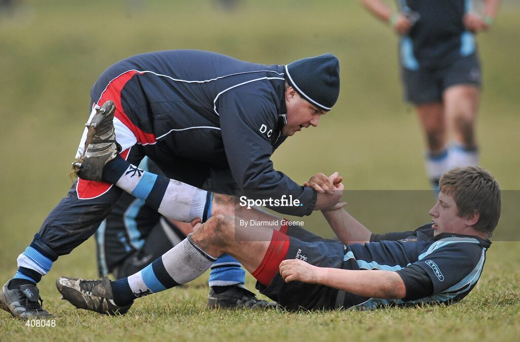 3 March 2010; Castletroy's Michael Dooley is helped to his feet by Physio Dave Cross. Avonmore Munster Rugby Schools Senior Cup Semi-Final, Rockwell v Castletroy College, Clanwilliam Park, Tipperary Town, Tipperary. Picture credit: Diarmuid Greene / SPORTSFILE