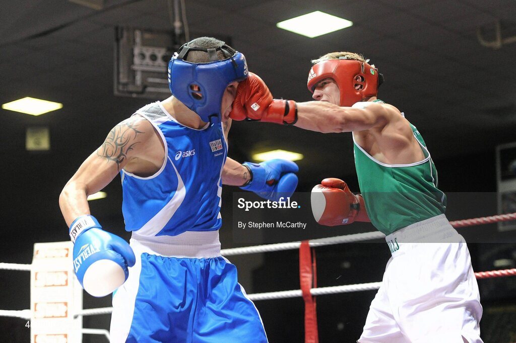 12 March 2010; Eric Donovan, Ireland, exchanges punches with Domenico Valentino, Italy, during their 60Kg bout. Elite International, National Stadium, Dublin. Picture credit: Stephen McCarthy / SPORTSFILE