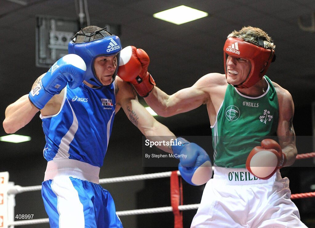 12 March 2010; Eric Donovan, Ireland, exchanges punches with Domenico Valentino, Italy, during their 60Kg bout. Elite International, National Stadium, Dublin. Picture credit: Stephen McCarthy / SPORTSFILE