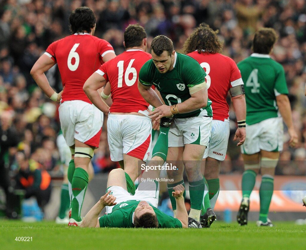 13 March 2010; Brian O'Driscoll, Ireland, receives treatment for leg cramp from team-mate Cian Healy. RBS Six Nations Rugby Championship, Ireland v Wales, Croke Park, Dublin. Picture credit: Ray McManus / SPORTSFILE