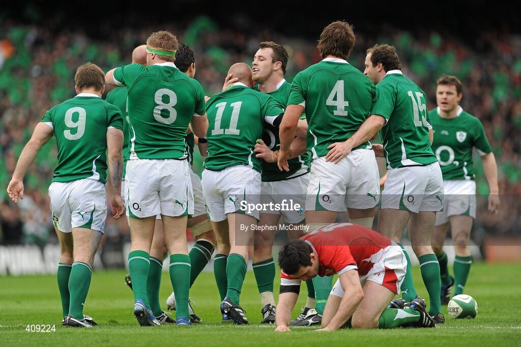 13 March 2010; Cian Healy and Ireland team-mates celebrate with Keith Earls, 11, after he scored his side's first try as Stephen Jones, Wales, falls dejected. RBS Six Nations Rugby Championship, Ireland v Wales, Croke Park, Dublin. Picture credit: Stephen McCarthy / SPORTSFILE