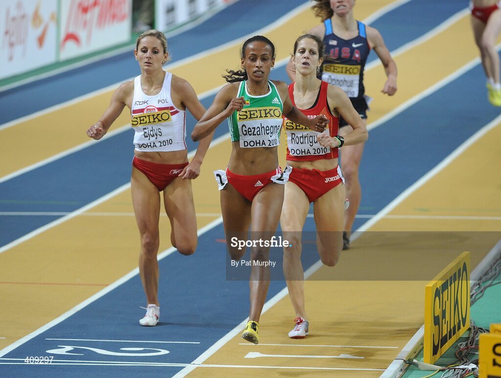 12 March 2010; Ethiopia's Kalkidan Gezahegne crosses the line ahead of Poland's Sylwia Ejdys, left, and Natalia Rodriguez, Spain, right, to win her Women's 1500m heat at the 13th IAAF World Indoor Athletics Championships, Doha, Qatar. Picture credit: Pat Murphy / SPORTSFILE