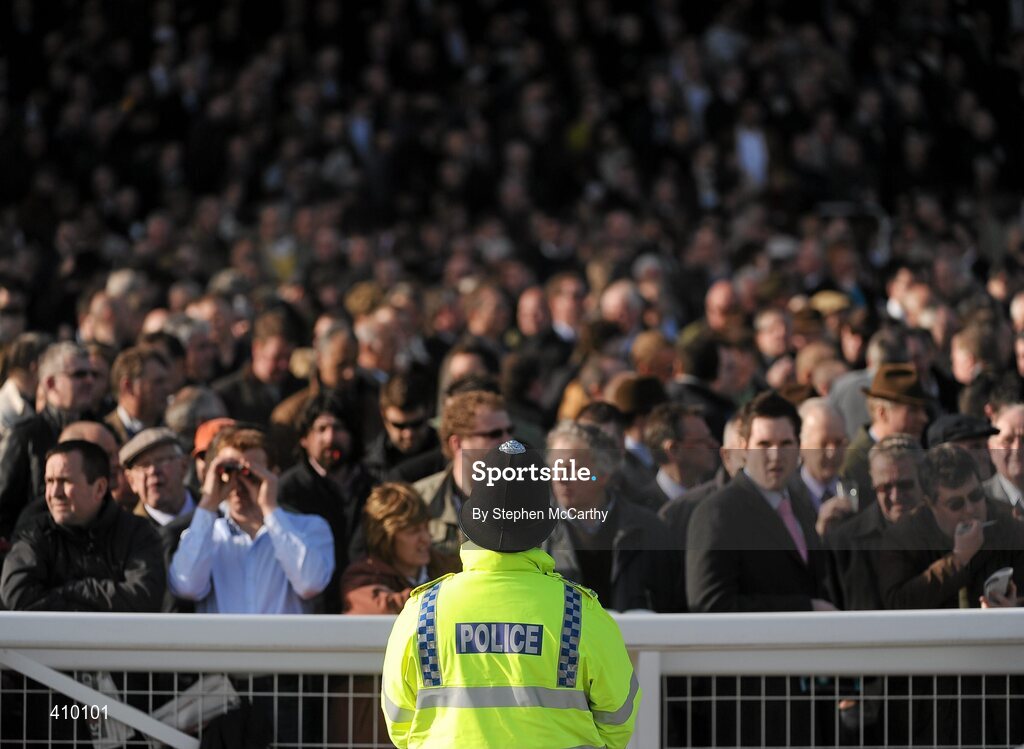 16 March 2010; A police officer keeps a watchful eye on the crowd during the Smurfit Kappa Champion Hurdle Challenge Trophy. Cheltenham Racing Festival - Tuesday. Prestbury Park, Cheltenham, Gloucestershire, England. Picture credit: Stephen McCarthy / SPORTSFILE