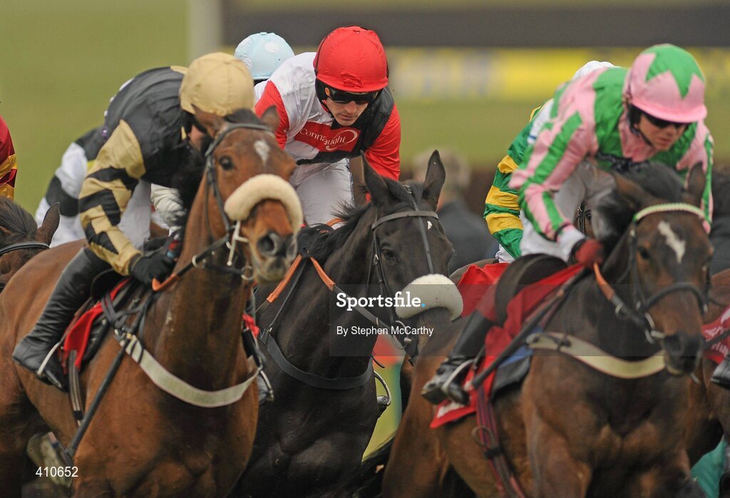 18 March 2010; Big Bucks, with Ruby Walsh up, red, white and black silks, on their way to winning the Ladbrokes World Hurdle. Cheltenham Racing Festival - Thursday. Prestbury Park, Cheltenham, Gloucestershire, England. Picture credit: Stephen McCarthy / SPORTSFILE