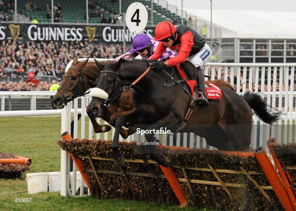 18 March 2010; Big Buck's, white and black silks, with Ruby Walsh up, jumps the last on their way to winning the Ladbrokes World Hurdle from second place Time for Rupert, with W.T. Kennedy up. Cheltenham Racing Festival - Thursday. Prestbury Park, Cheltenham, Gloucestershire, England. Photo by Sportsfile