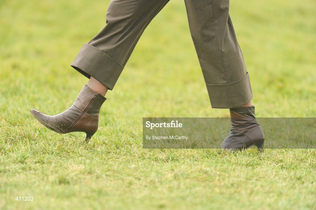 17 March 2010; A lady crosses the track ahead of the RSA Chase. Cheltenham Racing Festival - Wednesday. Prestbury Park, Cheltenham, Gloucestershire, England. Picture credit: Stephen McCarthy / SPORTSFILE