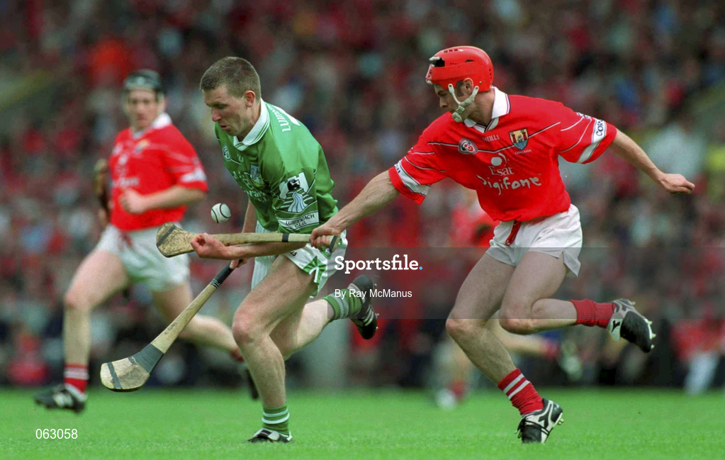 27 May 2001; Mark Foley of Limerick clears under pressure from Sean McGrath of Cork during the Guinness Munster Senior Hurling Championship Quarter-Final match between Cork and Limerick at Páirc Uí Chaoimh in Cork. Photo by Ray McManus/Sportsfile