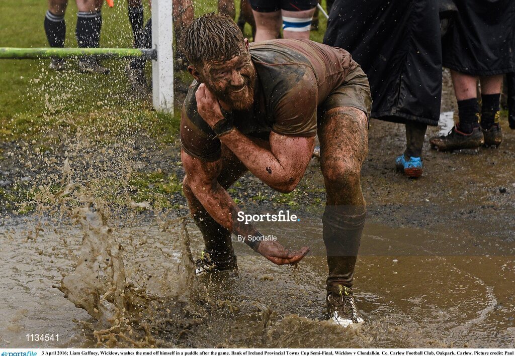 3 April 2016; Liam Gaffney, Wicklow, washes the mud off himself in a puddle after the game. Bank of Ireland Provincial Towns Cup Semi-Final, Wicklow v Clondalkin. Co. Carlow Football Club, Oakpark, Carlow. Photo by Sportsfile