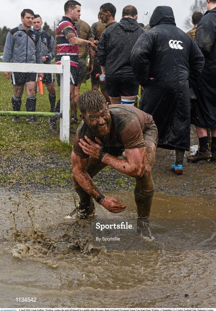 3 April 2016; Liam Gaffney, Wicklow, washes the mud off himself in a puddle after the game. Bank of Ireland Provincial Towns Cup Semi-Final, Wicklow v Clondalkin. Co. Carlow Football Club, Oakpark, Carlow. Photo by Sportsfile