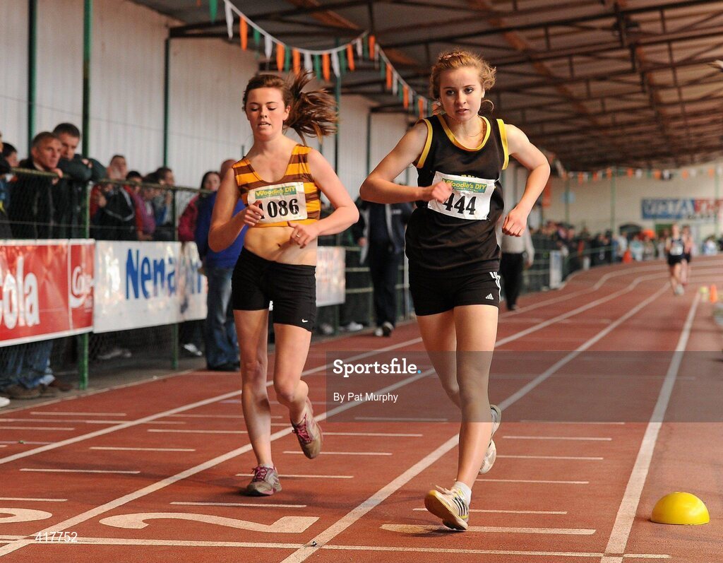 10 April 2010; Emma Prendeville, from Farranfore Maine Valley AC, right, crosses the finish line to win the U18 Girls 1500m Walk while Emma Doherty, from North Belfast Harriers AC, left, wins the U19 Girls 1500m Walk. Woodie's DIY Juvenile Indoor Championships, Nenagh Indoor Arena, Nenagh, Co. Tipperary. Picture credit: Pat Murphy / SPORTSFILE