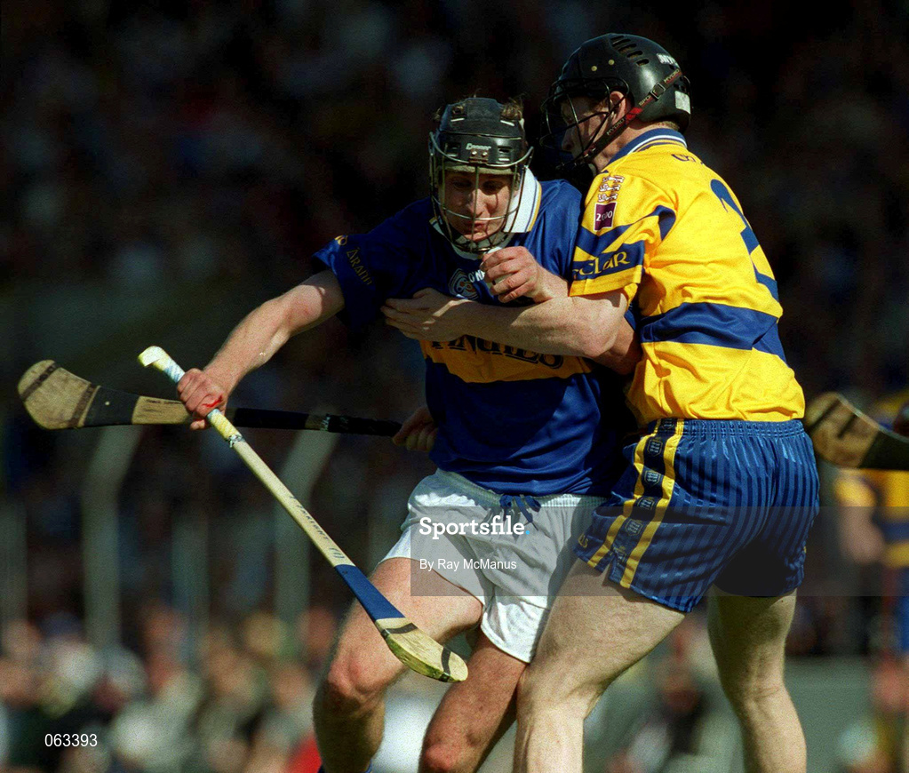 3 June 2001; Eddie Enright of Tipperary is challenged by Frank Lohan of Clare during the Guinness Munster Senior Hurling Championship Semi-Final match between Tipperary and Clare at Páirc Uí Chaoimh in Cork. Photo by Ray McManus/Sportsfile