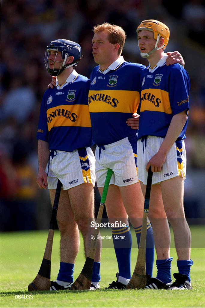 3 June 2001; Tipperary full forward line of, from left, Eoin Kelly, Declan Ryan and Lar Corbett, stand for the national anthem ahead of the Guinness Munster Senior Hurling Championship Semi-Final match between Tipperary and Clare at Páirc Uí Chaoimh in Cork. Photo by Brendan Moran/Sportsfile