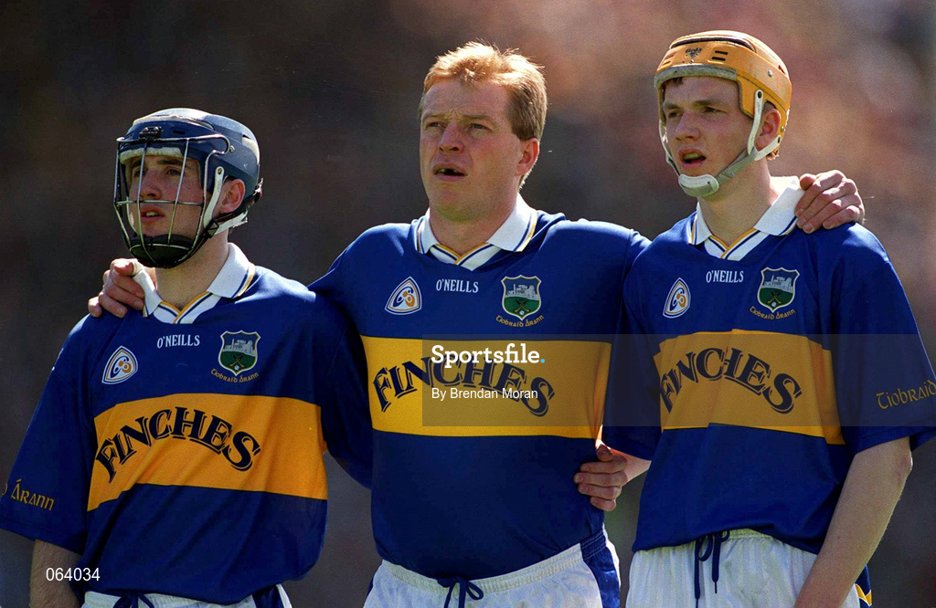 3 June 2001; Tipperary full forward line of, from left, Eoin Kelly, Declan Ryan and Lar Corbett, stand for the national anthem ahead of the Guinness Munster Senior Hurling Championship Semi-Final match between Tipperary and Clare at Páirc Uí Chaoimh in Cork. Photo by Brendan Moran/Sportsfile