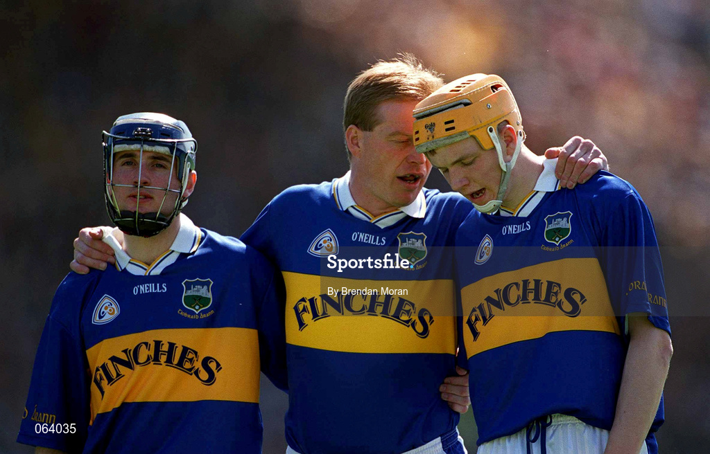 3 June 2001; Tipperary full forward line of, from left, Eoin Kelly, Declan Ryan and Lar Corbett, stand for the national anthem ahead of the Guinness Munster Senior Hurling Championship Semi-Final match between Tipperary and Clare at Páirc Uí Chaoimh in Cork. Photo by Brendan Moran/Sportsfile