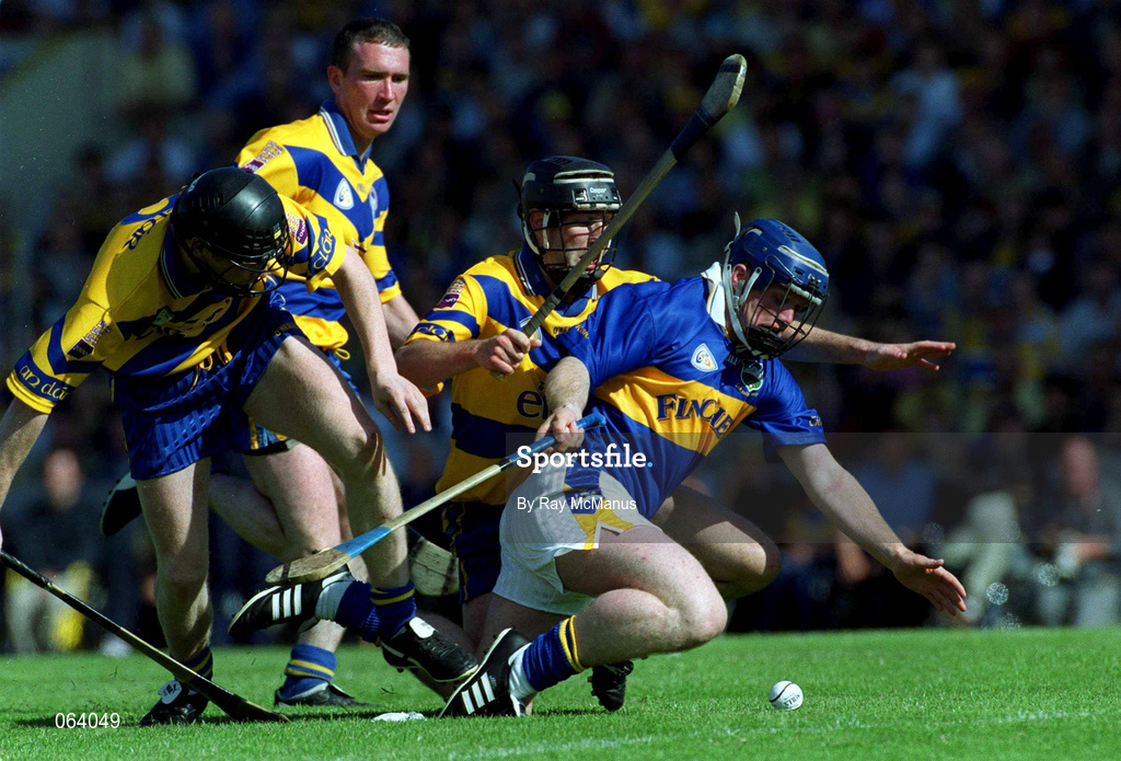 3 June 2001; Eugene O'Neill of Tipperary in action against Clare players, from left, Frank Lohan Brian Quinn and Sean McMahon during the Guinness Munster Senior Hurling Championship Semi-Final match between Tipperary and Clare at Páirc Uí Chaoimh in Cork. Photo by Ray McManus/Sportsfile