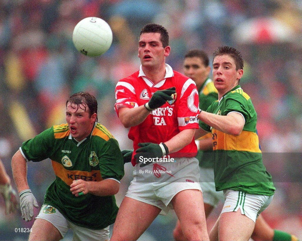 21 July 1996. Cork's Liam Honohan gets the ball away under pressure from Kerry's Gene 'Bingo' Driscoll, left, and Dara O'Se. Munster Senior Football Championship Final, Kerry v Cork, Pairc ui Chaoimh, Cork. Picture Credit: Ray McManus / SPORTSFILE.