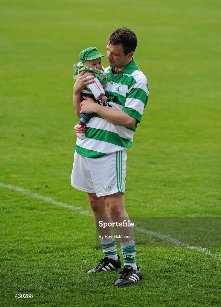 29 May 2010; Graham Denton, Shamrocks, watches the trophy presentation with his three month old nephew Lee Jordan. Leinster GAA Club Hurling League Division 2 Final, Shamrocks, Wexford, v Lucan Sarsfields, Dublin, Nowlan Park, Kilkenny. Picture credit: Ray McManus / SPORTSFILE