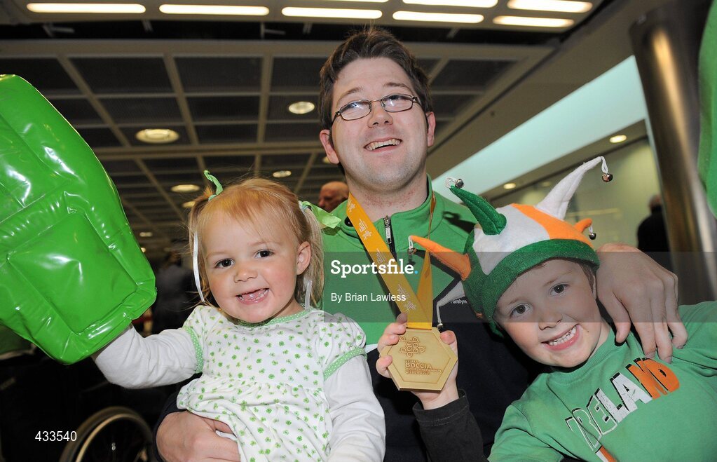 10 June 2010; Padraic Moran, from Bray, Co. Wicklow, celebrates with his niece Caoimhe Moran-Laffan, age 3, and nephew Fionn Moran-Laffan, age 5, on his return to Ireland after winning Gold in the BC1 Class at the CPISRA World Boccia Championships in Lisbon. The Bray local, sensationally beat home favourite Portugal’s Joao Paolo Fernandez by a score of 3:2 in a thrilling final at the Estádio Universitário in Lisbon’s University complex to take victory This is the end of a long Championship for Moran who earlier in the week led the Irish team to a 4th place finish in the BC1/BC2 combined team competition. Dublin Airport, Dublin. Picture credit: Brian Lawless / SPORTSFILE