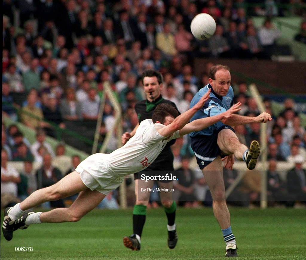 18 June 1994; Tommy Carr of Dublin shoots to score, despite the attempts by Glenn Ryan of Kildare during the Leinster Senior Football Championship Quarter-Final match between Dublin and Kildare at Croke Park in Dublin. Photo by Ray McManus/Sportsfile