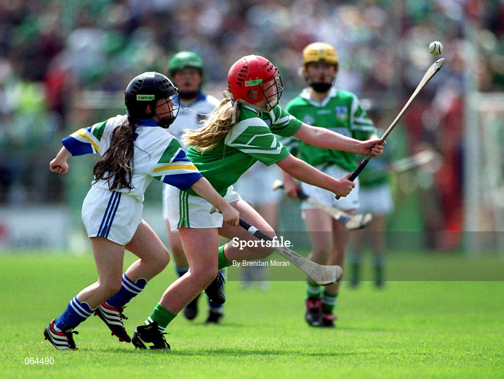 10 June 2001; Mairead Caulfield of Limerick in action against Jenny Larkin of Waterford during the DairyGold Munster Hurling Primary Schools game between Limerick and Waterford at half-time of the Guinness Munster Senior Hurling Championship Semi-Final match between Limerick and Waterford at Páirc Uí Chaoimh in Cork. Photo by Brendan Moran/Sportsfile