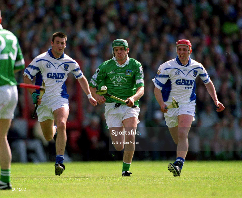 10 June 2001; Mike O'Brien of Limerick in action against Dan Shanahan, left and Johnny Brenner of Waterford during the Guinness Munster Senior Hurling Championship Semi-Final match between Limerick and Waterford at Páirc Uí Chaoimh in Cork. Photo by Brendan Moran/Sportsfile