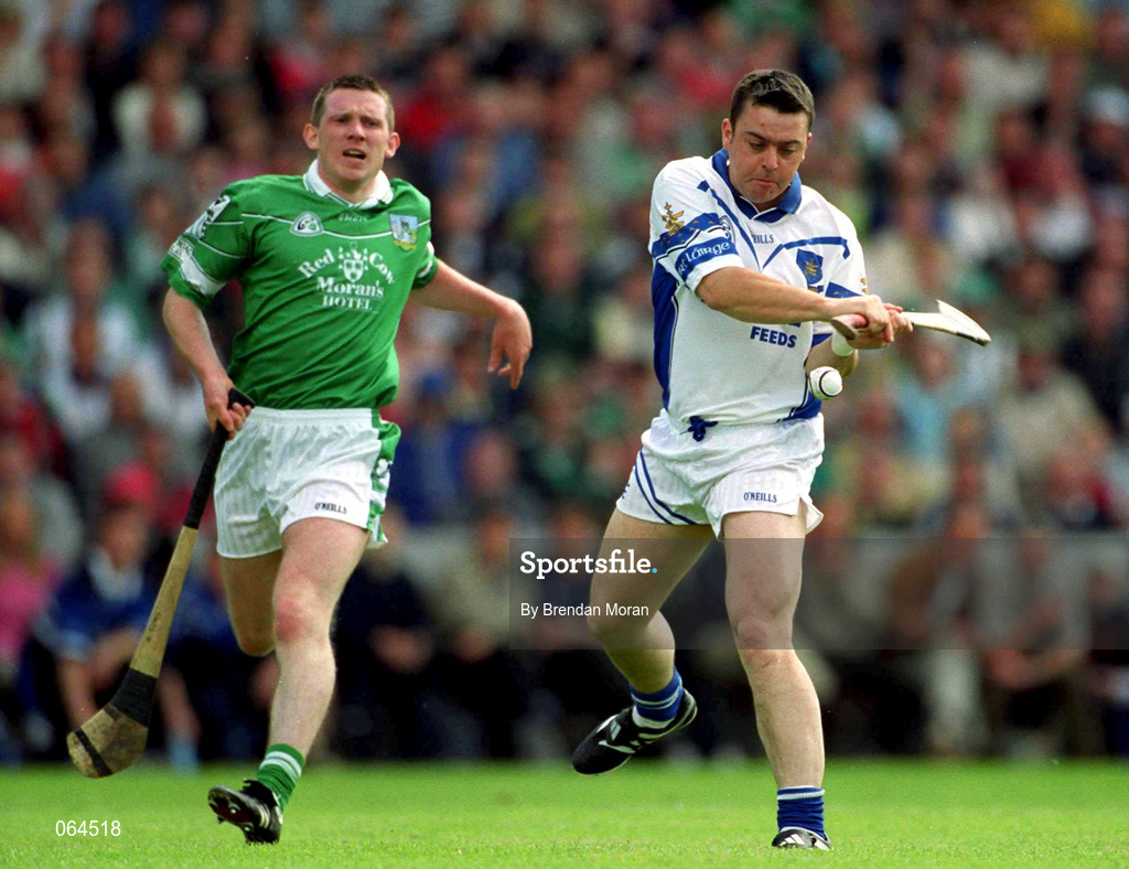 10 June 2001; Paul Flynn of Waterford scores his side's second goal depite the efforts of Mark Foley of Limerick during the Guinness Munster Senior Hurling Championship Semi-Final match between Limerick and Waterford at Páirc Uí Chaoimh in Cork. Photo by Brendan Moran/Sportsfile