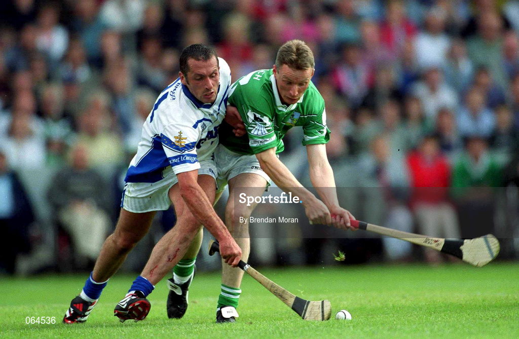 10 June 2001; Peter Queally of Waterford in action against Eoin O'Neill of Limerick during the Guinness Munster Senior Hurling Championship Semi-Final match between Limerick and Waterford at Páirc Uí Chaoimh in Cork. Photo by Brendan Moran/Sportsfile